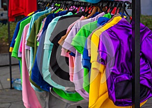 Rack of colorful clothes for dogs in a pet shop, animal fashion
