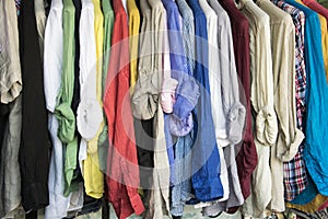 A rack of colorful shirts hanged for sale at the market