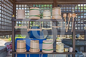 Rack containing traditional water basins, or sukubaiâ€‹,  and ladles, or hishaku, Kanazawa, Japan