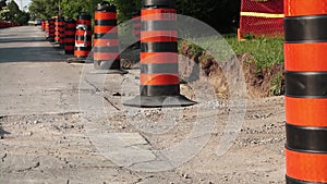 Rack focus long line row of orange and black traffic delineator pylon barrels