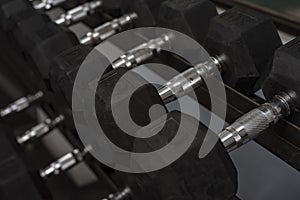 A rack of hex dumbbells at a gym or fitness club. Workout and pyramid training or running the rack for serious bodybuilding