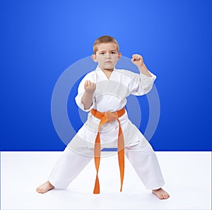 In rack is karate is standing athlete with an orange belt