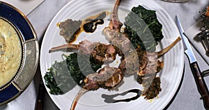 A rack of lamb with crusted mint sauce, with spinach and mashed potatoes