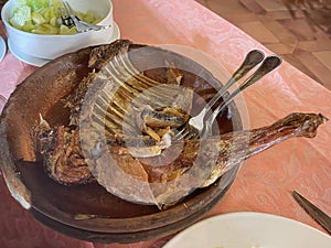 a rack of lamb and a leg of lamb roasted in a clay pot, traditional artisan food, cooked in a wood oven photo