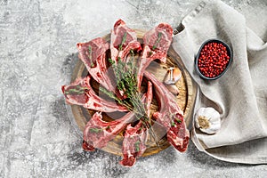 Rack of lamb , raw meat with bone, chops with salt, pepper. Gray background. Top view