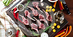 Rack of lamb , raw meat with bone on rustic kitchen table at wooden background.