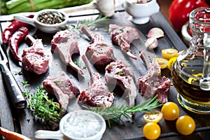 Rack of lamb , raw meat with bone on rustic kitchen table at wooden background.