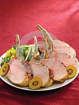 Rack of pork crusted with pepper corns with kiwis