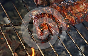 Rack of pork spare ribs on fire barbecue grill