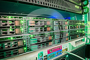 A rack with powerful data processing servers installed in the data center server room. Front panel of powerful computers.