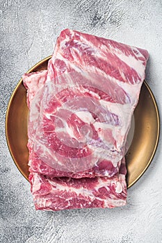 Rack of raw pork spare ribs. White background. Top view