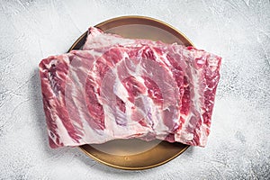 Rack of raw pork spare ribs. White background. Top view