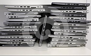 Rack with a stack of laptops in the storage room