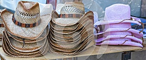 Rack of straw cowboy hats on sale