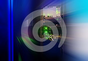 Rack with telecommunications network equipment in the data center with blur photo