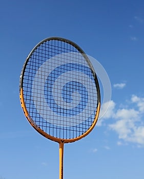 Racket for badminton on blue sky