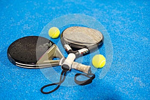 rackets paddle with two balls on blue background