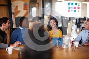 Racking their brains in the boardroom. a group of businesspeople meeting in the boardroom.