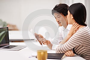 Racking their brains on this project. two business colleagues discussing work on a tablet.