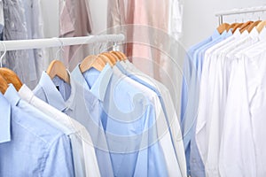 Racks with clean clothes on hangers