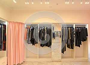 Racks with clothes and a fitting room a cabin in shop