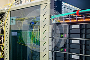 Racks with computer equipment are  close-up. Modern telecommunication cabinets are located in the data center server room