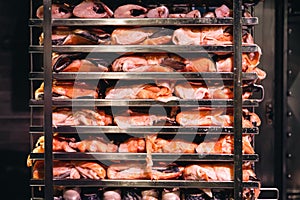 Racks of salmon smoking in a small smoker.