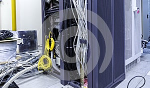 Racks with servers, computer equipment and connected twisting and coiling internet wires photo
