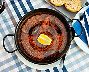 Racy seafood paella with mussels, calamari and prawns