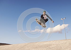 A rad day at the skate park. A young man doing tricks on his skateboard at the skate park.