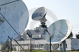 Radar antenna on satellite links center, telecommunication tower, wireless communication concept, clear blue sky