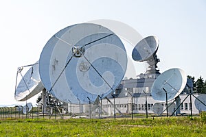 Radar antenna on satellite links center, telecommunication tower, wireless communication concept, clear blue sky