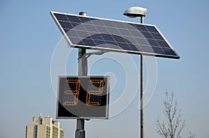 Radar to measure the speed of vehicles in the city. A reflective green sign on a pole with LED light numbers informs car drivers h