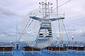 Radars on the top cruise liner deck. Navigation equipment, antennas and searchlights on the deckhouse of ocean liner.