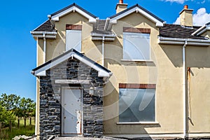 Radharc An Seascan, Meenmore, Dungloe, County Donegal, Ireland - May 30 2021 : The 2007 built houses sinking into the