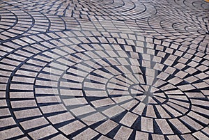 Radial pattern of bricks laid on the ground