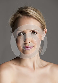 Radiant blonde woman with natural makeup and pink lips