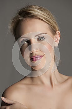 Radiant blonde woman with natural makeup and pink lips