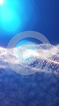 Radiant burst of soft blue light above a shimmering field of glowing particles on a cool gradient background