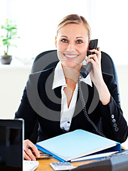 Radiant businesswoman phoning in her office