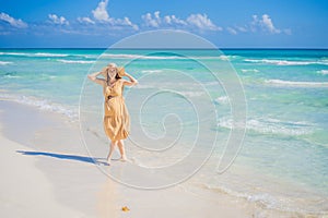 Radiant and expecting, a pregnant woman stands on a pristine snow-white tropical beach, celebrating the miracle of life