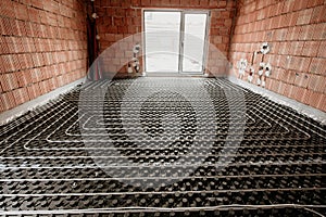 Radiant floor construction installation with flexible pipes. Installation of underfloor heating