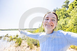 Radiant Freedom: Joyful Woman Embracing Nature's Beauty at a Forest Lake, Free Happy Woman Enjoying Nature on a