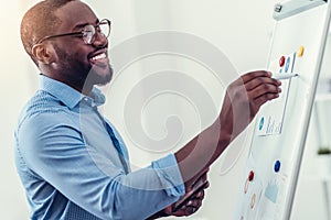 Radiant millennial employee preparing presentation in office