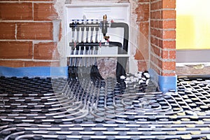 Radiant underfloor heating hydronic manifold with flexible tubing.