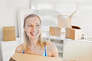 Radiant woman holding boxes