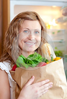 Radiant woman holding a grocery bag