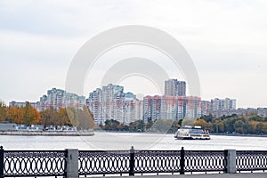 Radiated Moskva river, pleasure motor ship against the background of a residential microdistrict, Moscow, October 2020