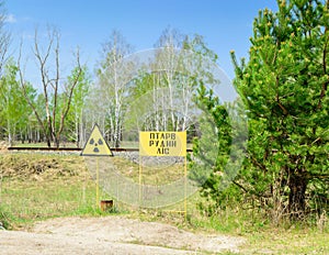 Radiation hazard sign in the red forest near the town of Pripyat. Chernobyl Exclusion Zone.