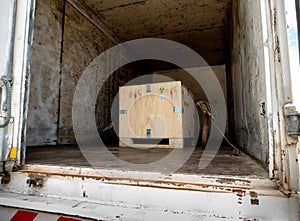 Radiation label beside the transport wooden box Type A package in the truck